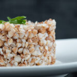 Delicious buckwheat with greens on a white plate. High quality photo